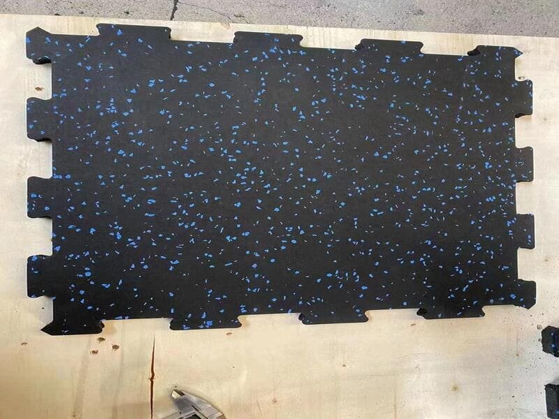 A close-up shot focusing on the precise puzzle-piece connection of two heavy-duty rubber interlocking mats.